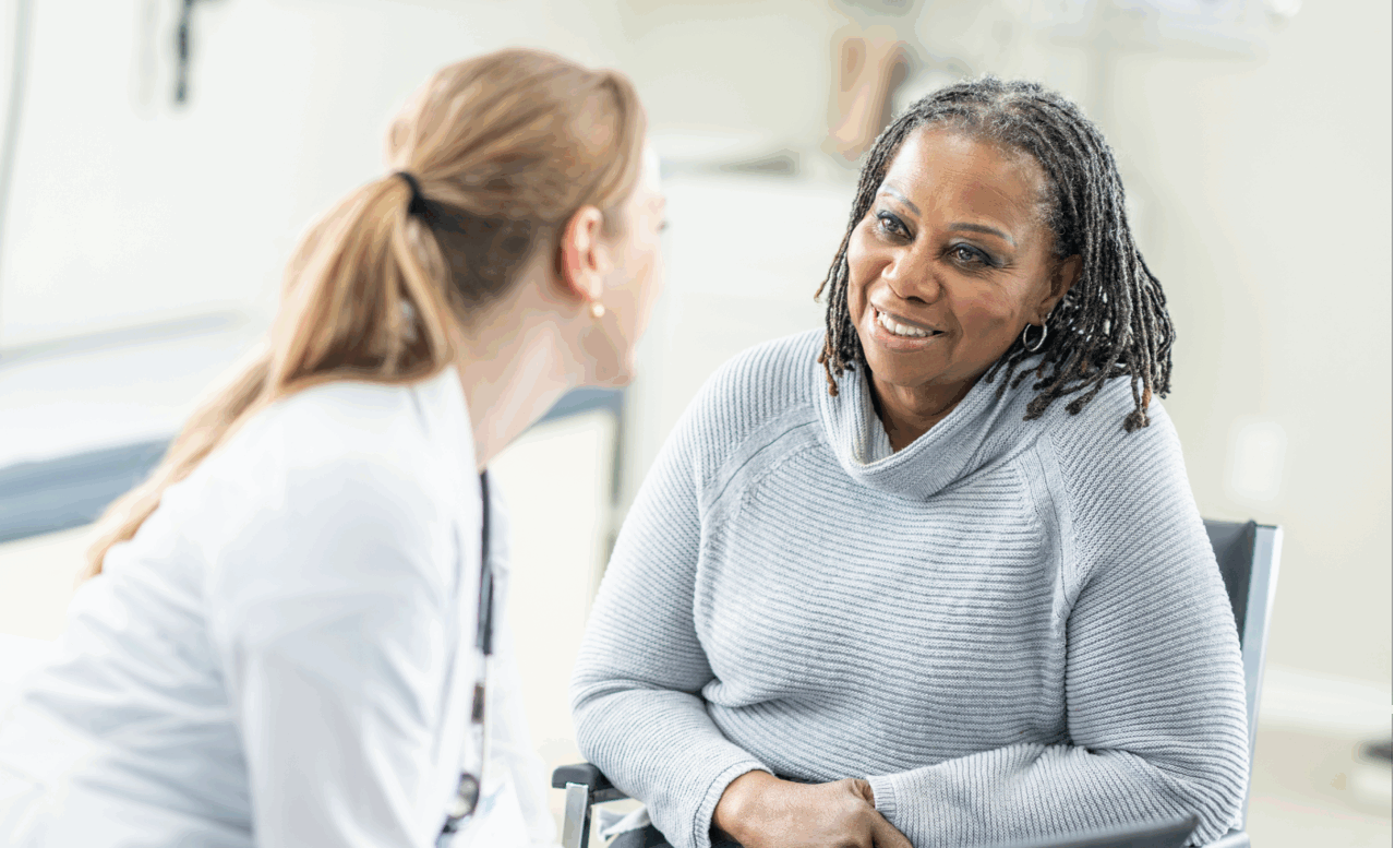 A medical practitioner conversing with a patient in a healthcare setting.